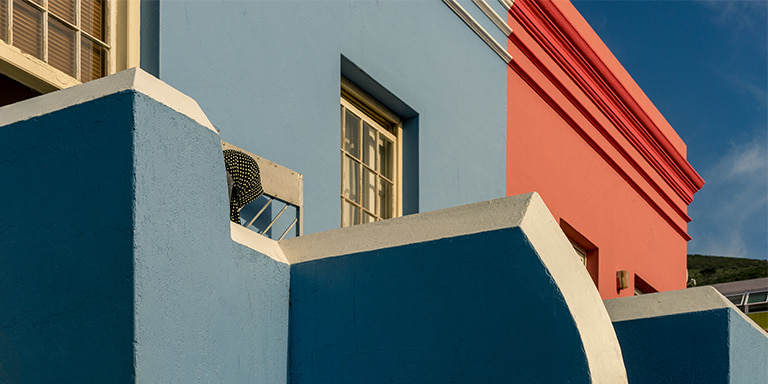 An insured, freshly painted multicoloured building in pristine condition.