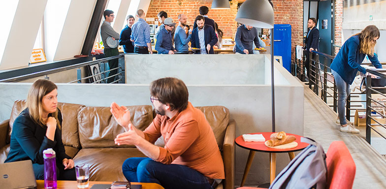 A business meeting in a modern office lounge, highlighting the importance of fidelity insurance in South Africa in protecting companies from employee fraud and theft.