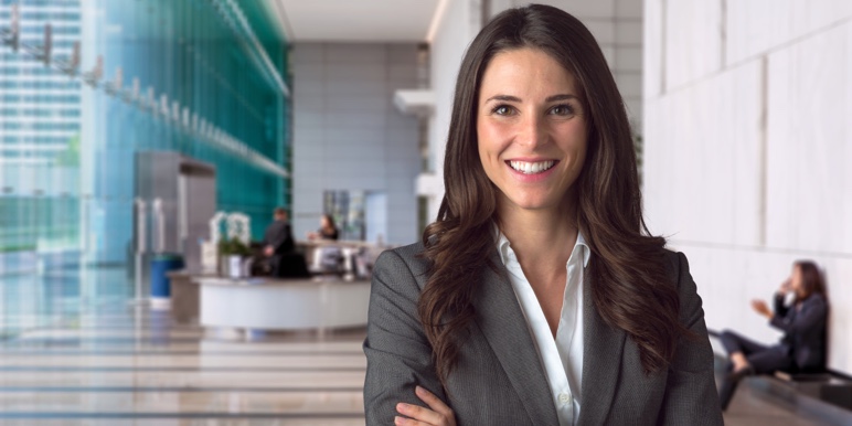 A smiling female executor dressed in a formal suit