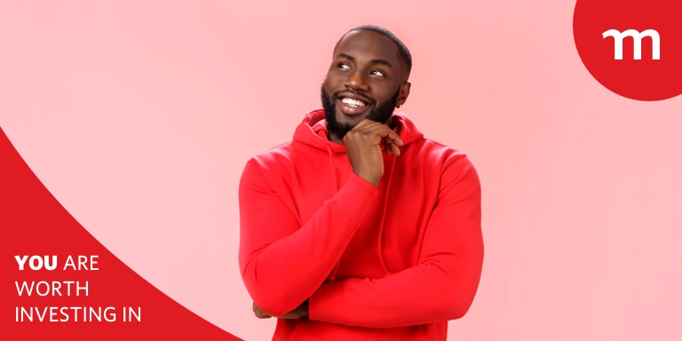 Young black man in a red sweater posing with his hand on his chin.