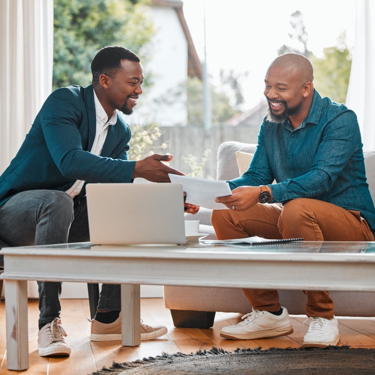 An independent financial adviser with a subcode to practice with Momentum, sitting with their client and giving them financial advice for success.