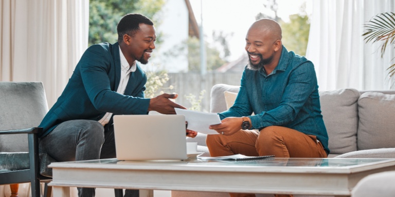 An independent financial adviser with a subcode to practice with Momentum, sitting with their client and giving them financial advice for success.