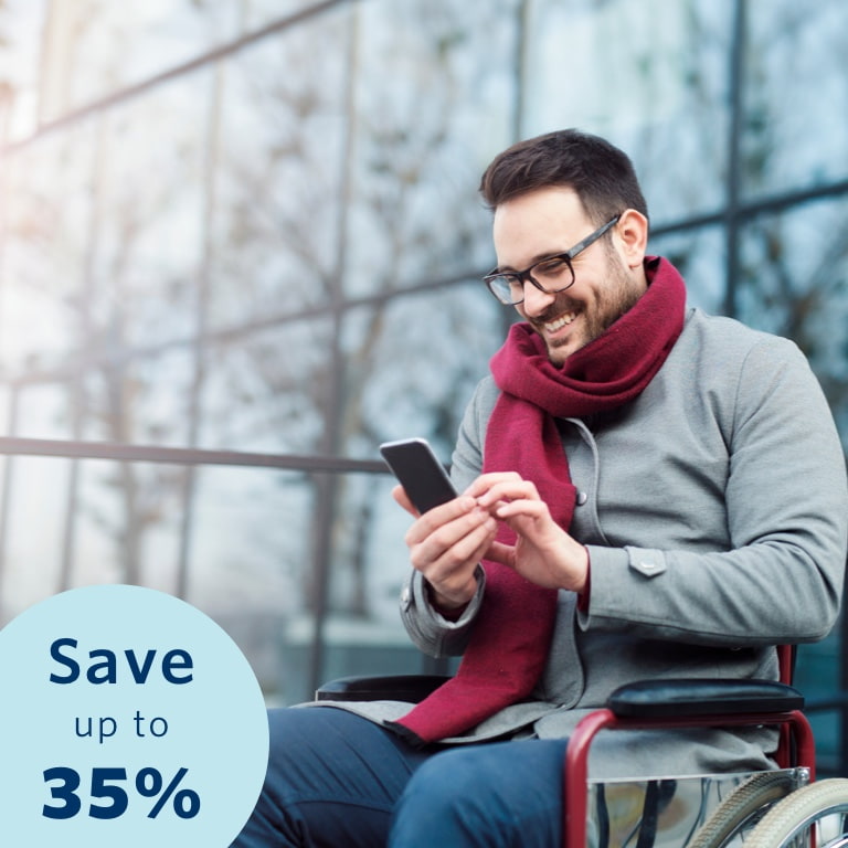 Young man seated in a wheelchair, busy doing an online disability cover quote on his cell phone. He’s smiling because he knows he could qualify for up to a 35% discount on his monthly premiums with Momentum Life Returns.