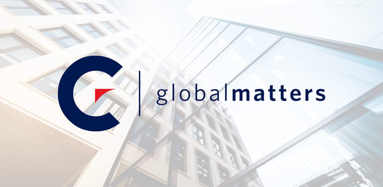 The Momentum Global Matters logo against a faded multistory office building backdrop and a light blue sky.