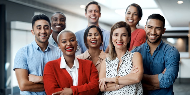 A successful team of colleagues standing in a power pose for the camera.