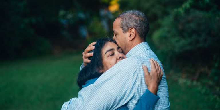 Loving senior couple hugging and consoling each other.
