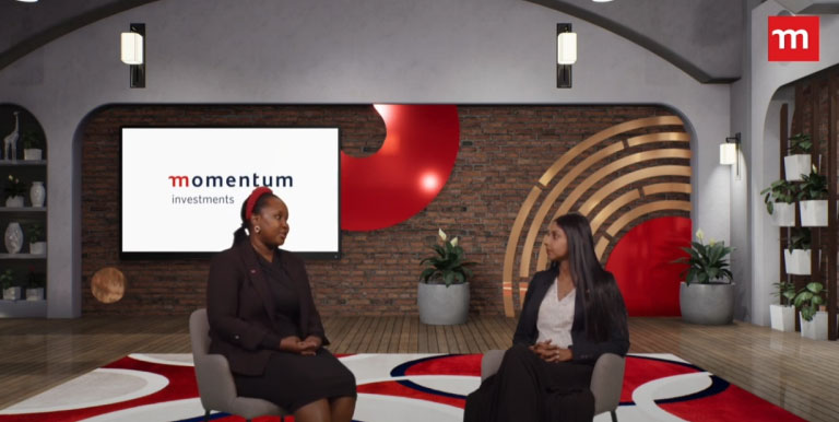 Momentum Investments employees discussing economic events in-studio.
