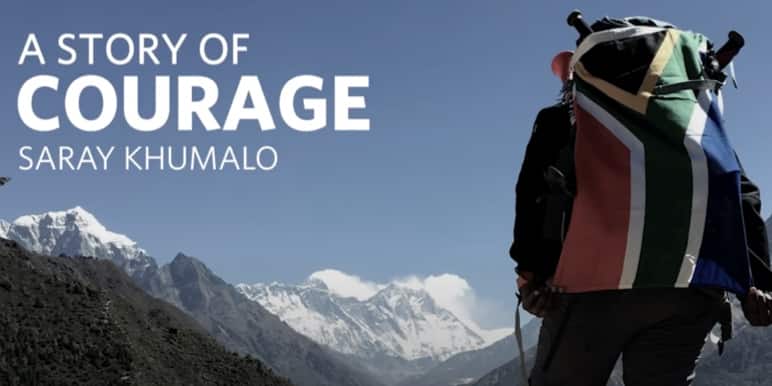 Saray Khumalo looks up to Mount Everest while carrying the South African flag on her backpack.