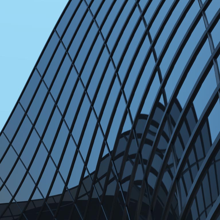 Modern architecture building in Vienna, Austria. A skyscraper with curved glass and steel exterior wall of a modern high-rise office building against a blue sky backdrop.