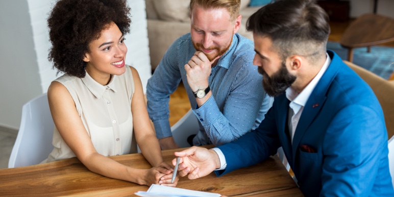 A couple consulting with a financial adviser about their retirement investments.